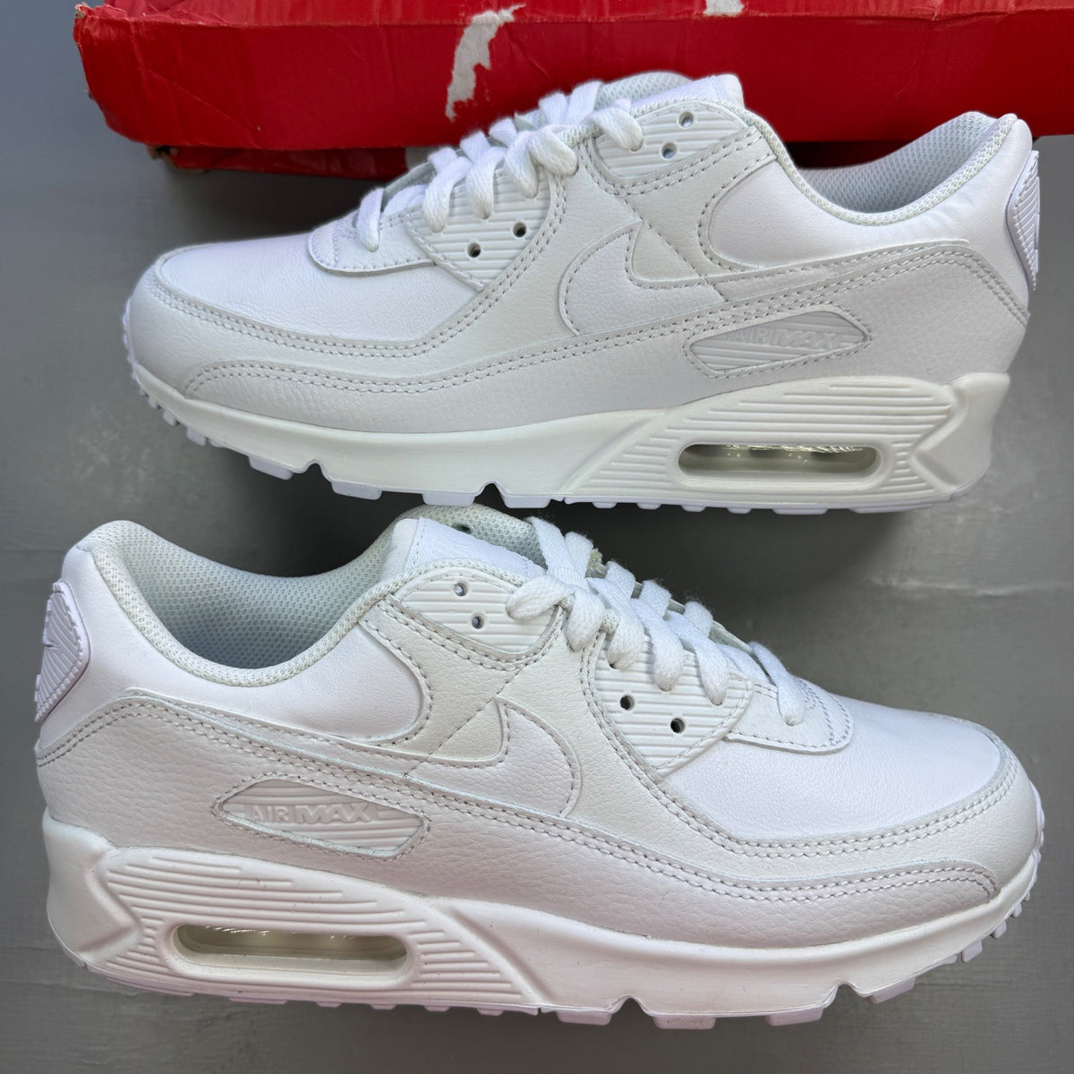 Nike deck shoes white leather with logo and minimalist design.