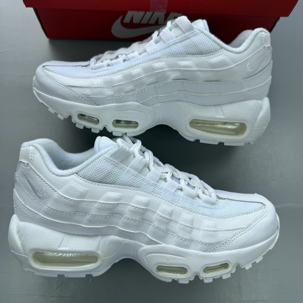 Nike Air Max 95 Recraft white trainers with distinctive layered design and air cushioning.