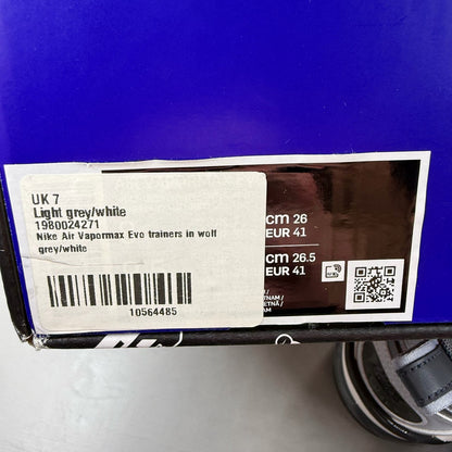 Nike grey trainers with Air cushioning, sleek design, and logo detail.