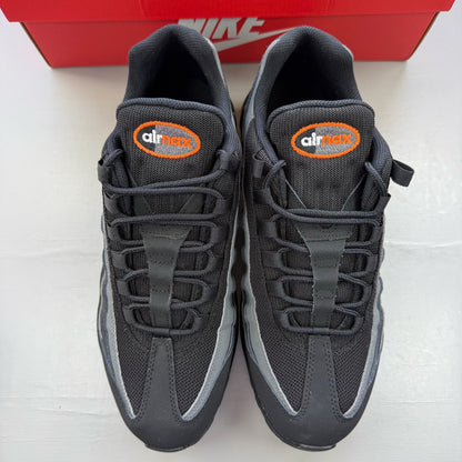 Nike Air Max 95 black grey trainers with safety orange accents and logo detailing.