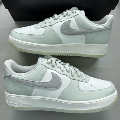 Nike Air Force 1 grey low-top sneakers with light silver accents and white sole.