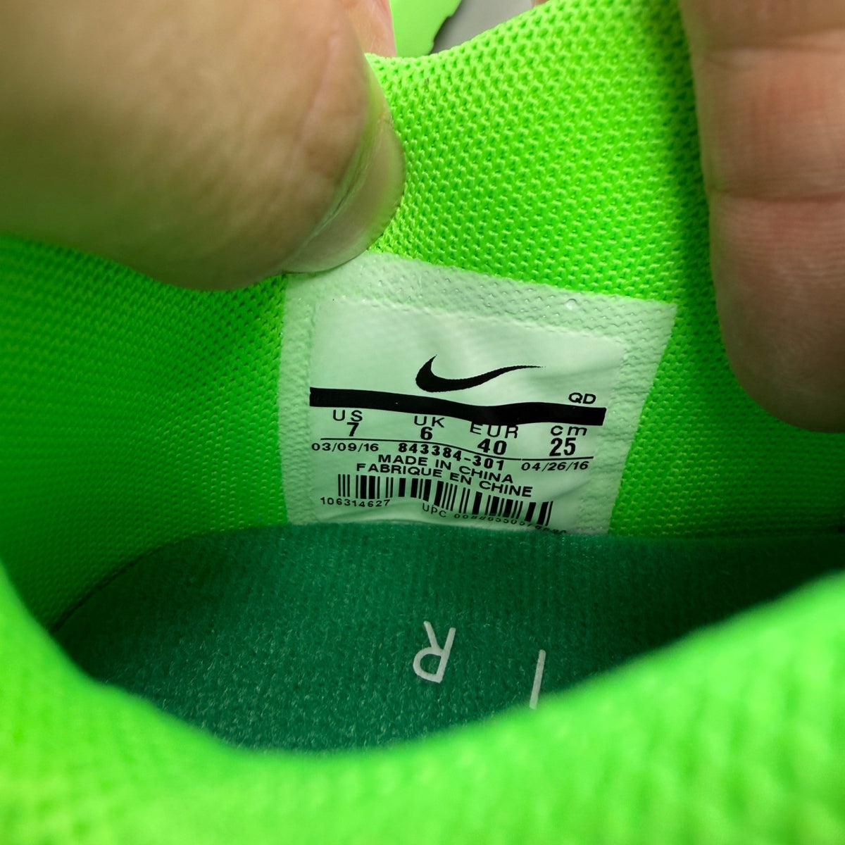 Nike trainers green Flyknit upper with Air Max cushioning and logo detail.