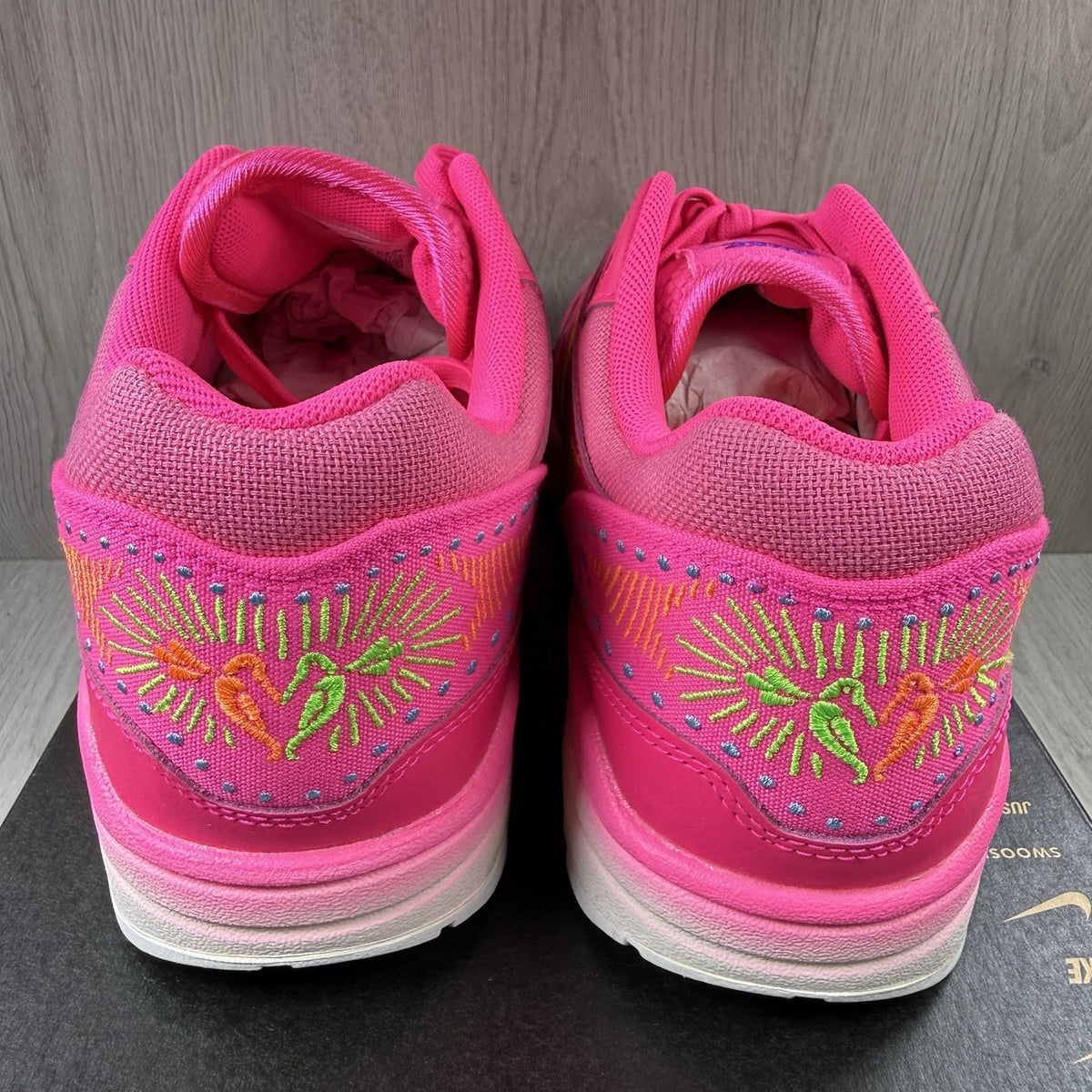 Nike Air Max 1 PRM trainers pink with Día De Muertos pattern and white accents.