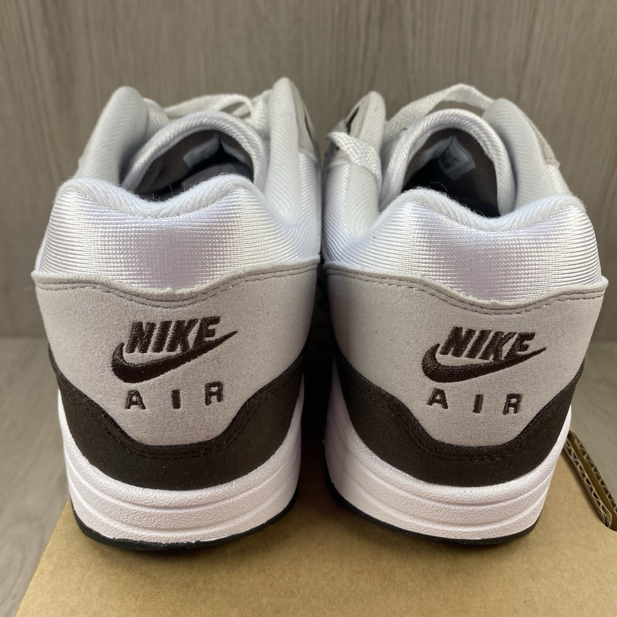 Nike Air Max 1 '87 trainers white with grey accents and brown detailing.