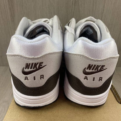 Nike Air Max 1 '87 trainers white with grey accents and brown detailing.