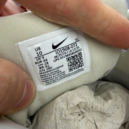 Nike Air Max 90 beige trainers with swoosh logo and mesh detailing.