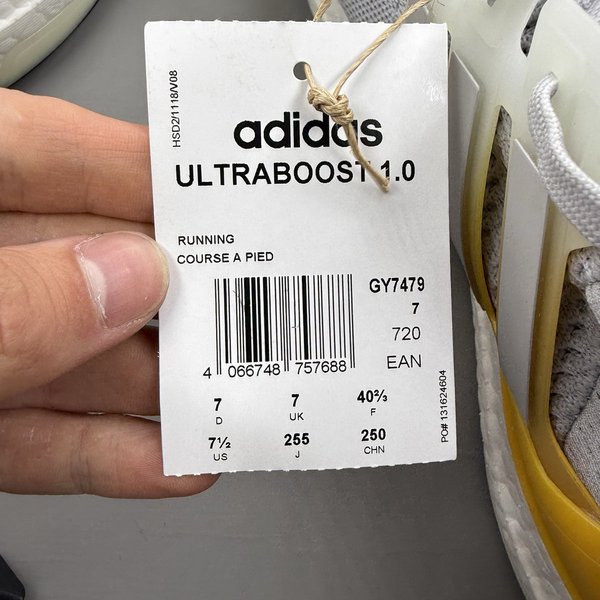 Adidas Ultra Boost 1.0 grey trainers with bold gold accents and white sole.