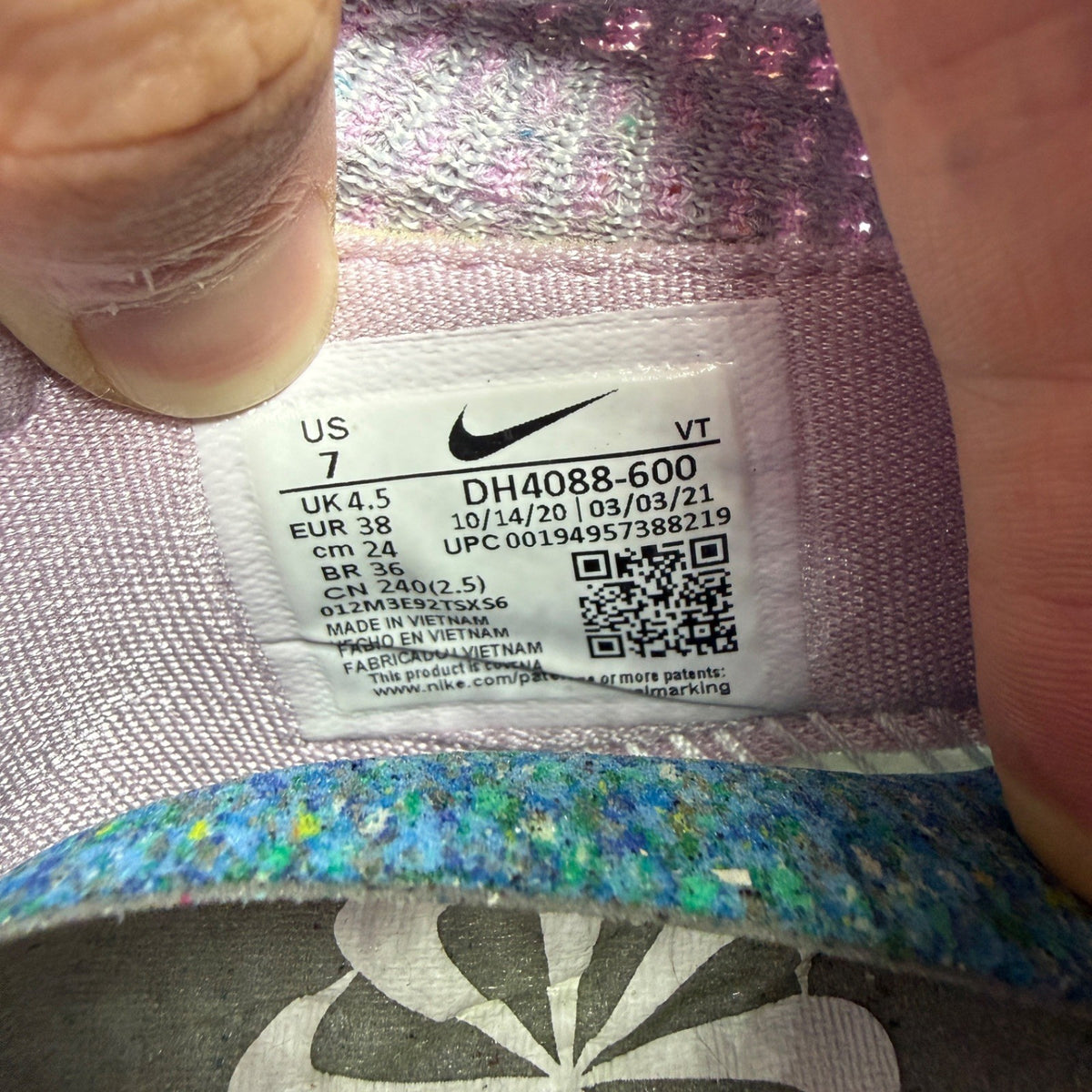Nike trainers pink Flyknit upper with Air cushioning and logo detail.