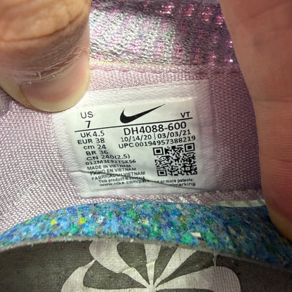 Nike trainers pink Flyknit upper with Air cushioning and logo detail.