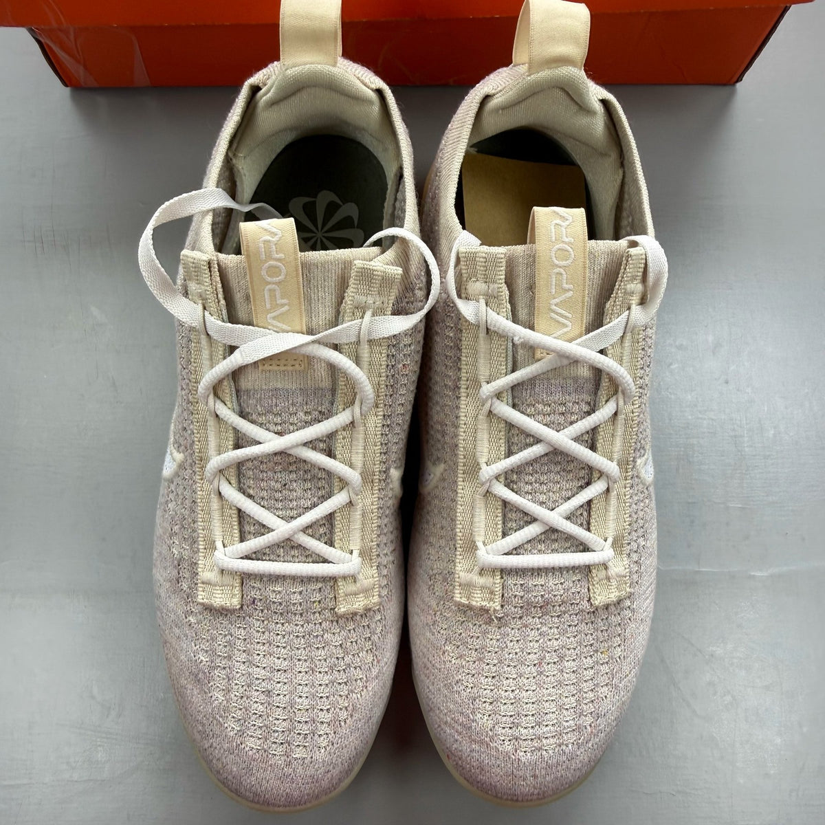 Nike Air VaporMax 2021 FK white trainers with breathable knit upper and signature swoosh logo.