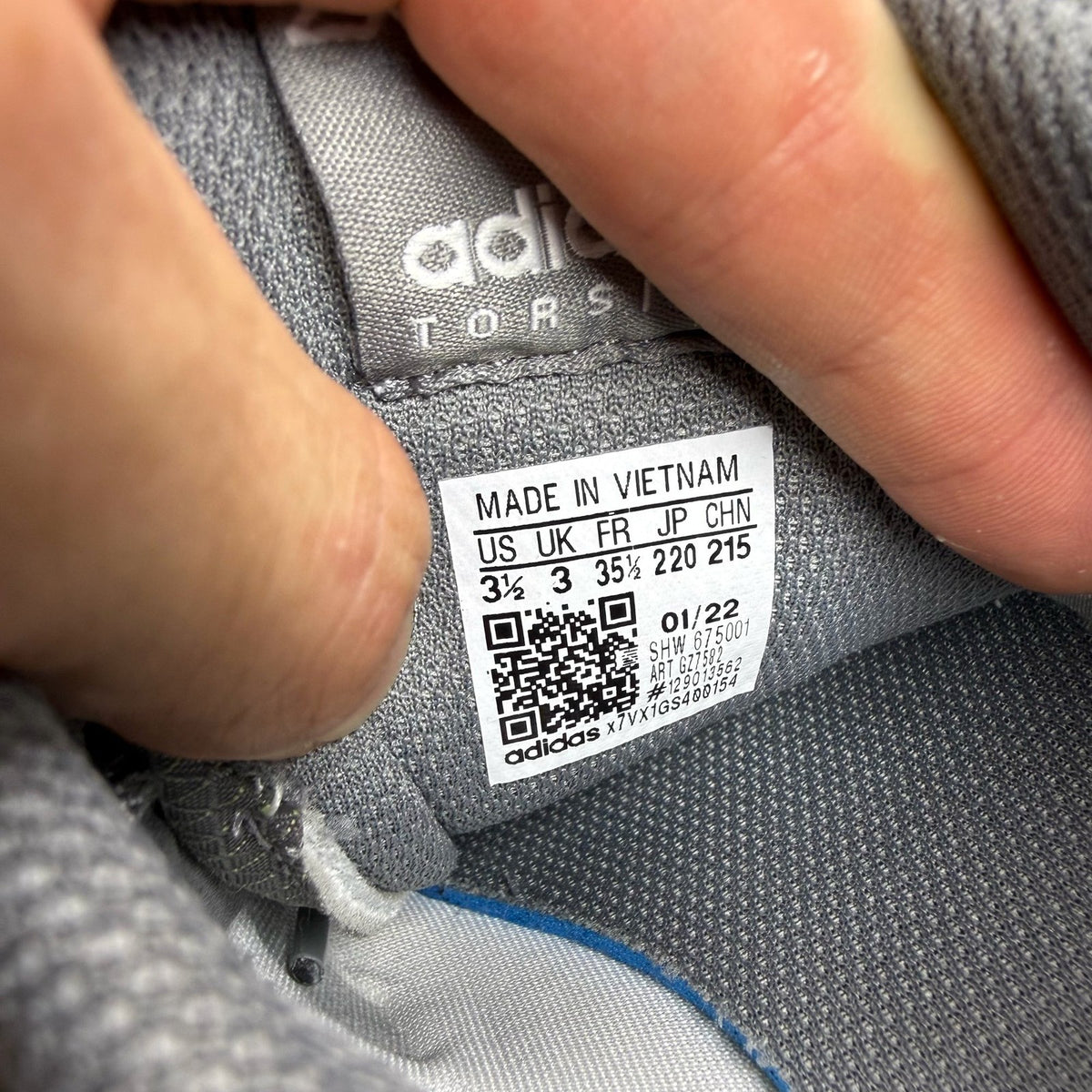 Adidas grey ZX Flux trainers with white accents and logo detail.