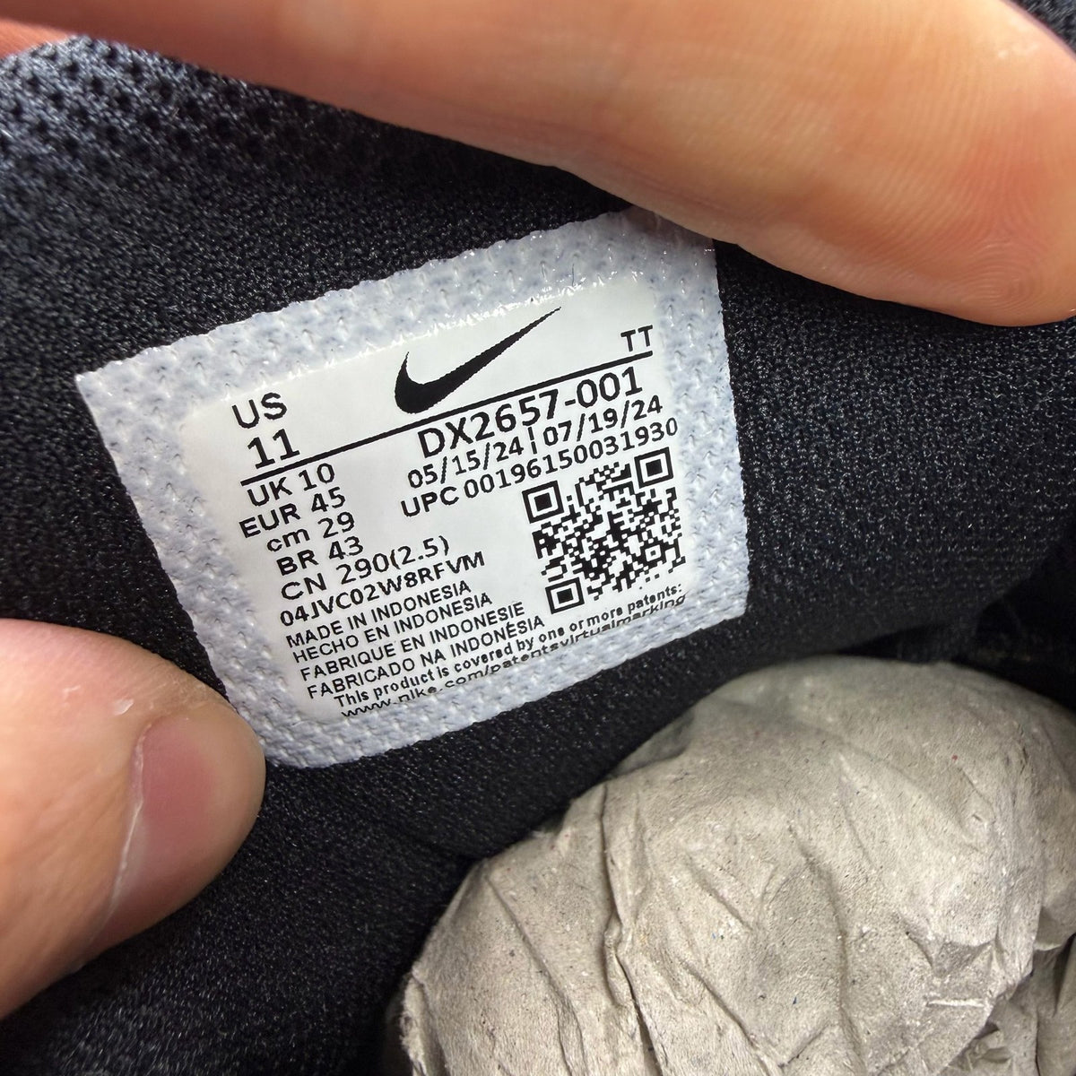 Nike Air Max 95 black grey trainers with safety orange accents and logo detailing.