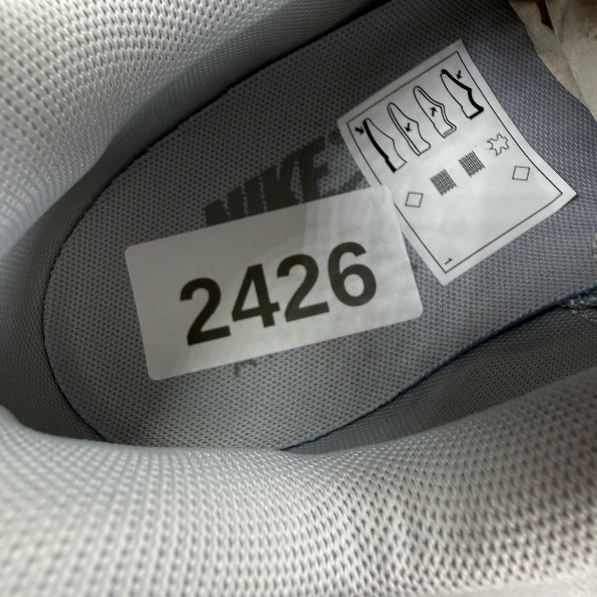 Nike Air Max 95 white trainers with big bubble sole and reflective detailing.