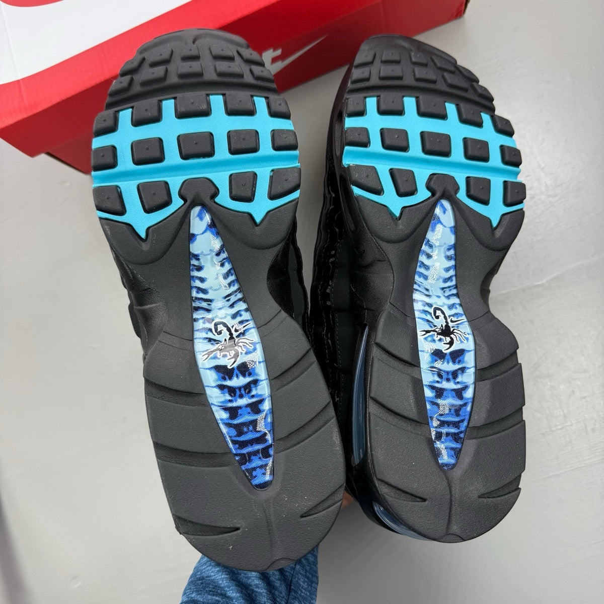 Nike Air Max 95 black sneakers with blue accents and big bubble sole design.