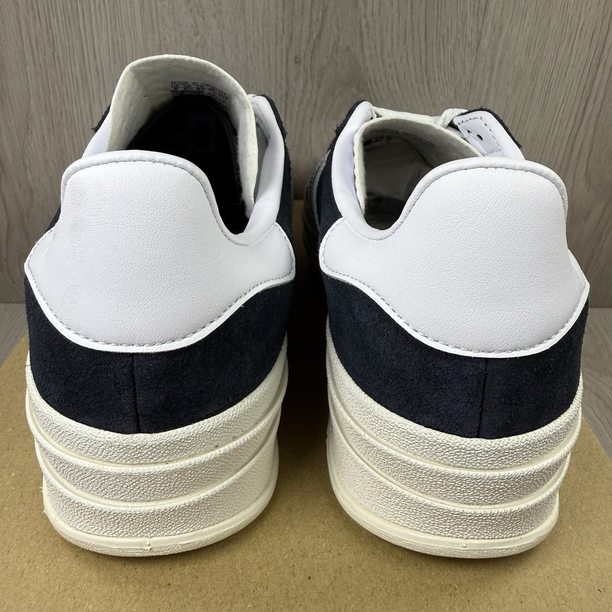 Adidas Gazelle Bold black trainers with white stripes and logo detailing.