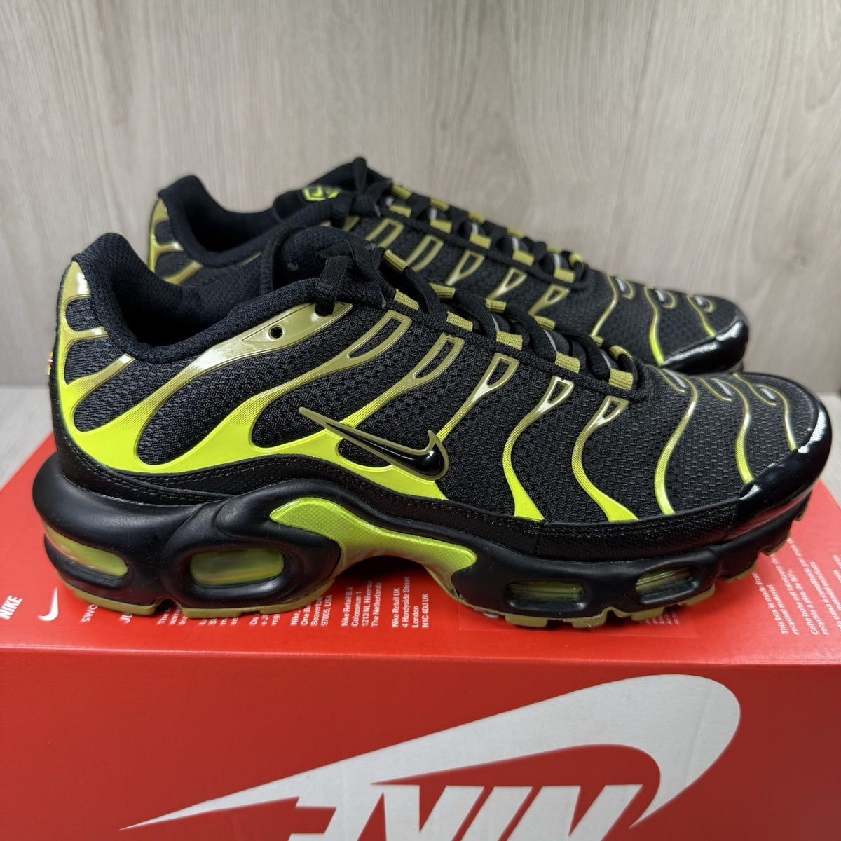 Nike Air Max Plus TN trainers black with moss green accents and signature logo.