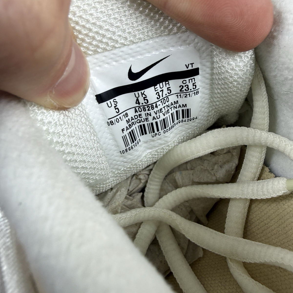 Nike Air Max Deluxe SE beige trainers with unique pattern and logo details.