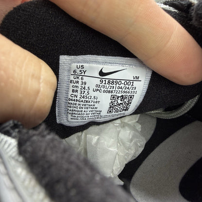 Nike Air Max 97 silver trainers with metallic finish and signature swoosh logo.