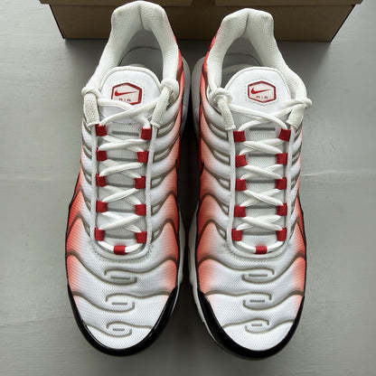 Nike Air Max Plus TN white trainers with black and university red accents, mesh material.