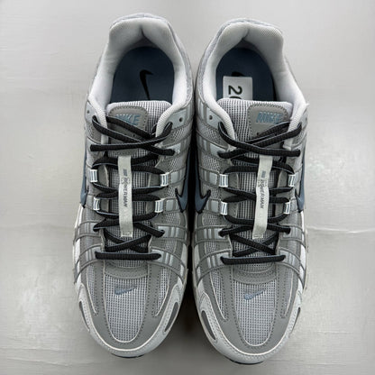 Nike grey trainers with blue accents and mesh material, featuring iconic swoosh logo.