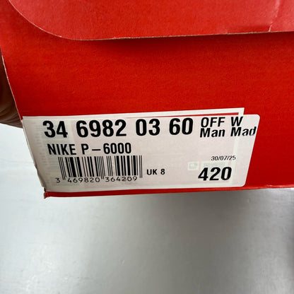 Nike P-6000 trainers white with red accents and mesh detailing, brand logo on tongue.