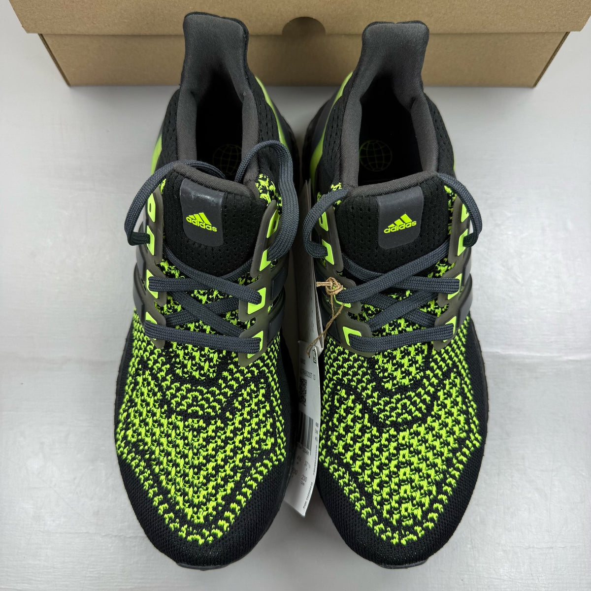 Adidas black Ultraboost 1.0 trainers with Lucid Lemon accents and breathable mesh upper.
