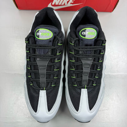 Nike Air Max 95 black trainers with green strike accents and textured upper.