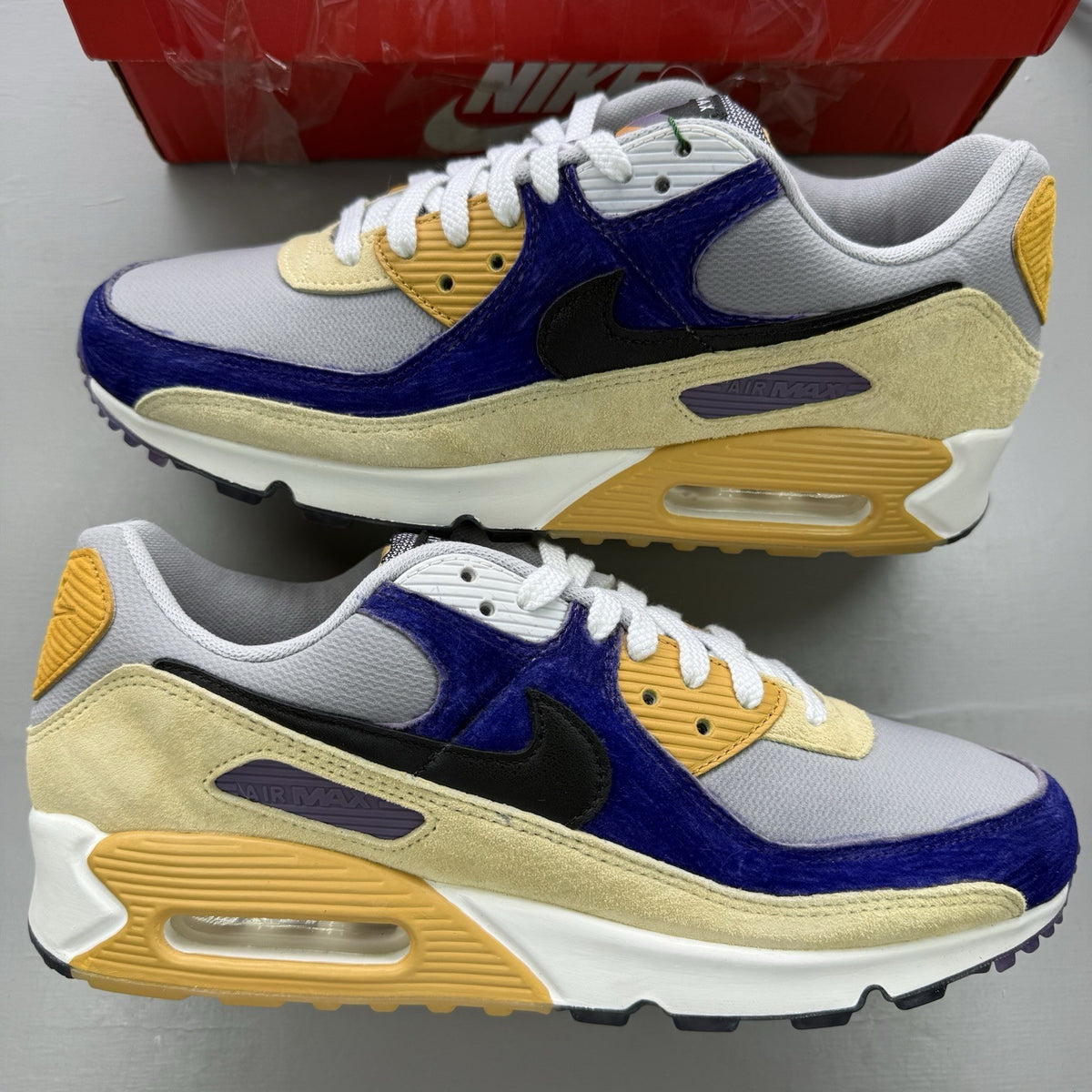 Nike Air Max 90 trainers black with custom blue accents and logo detail.