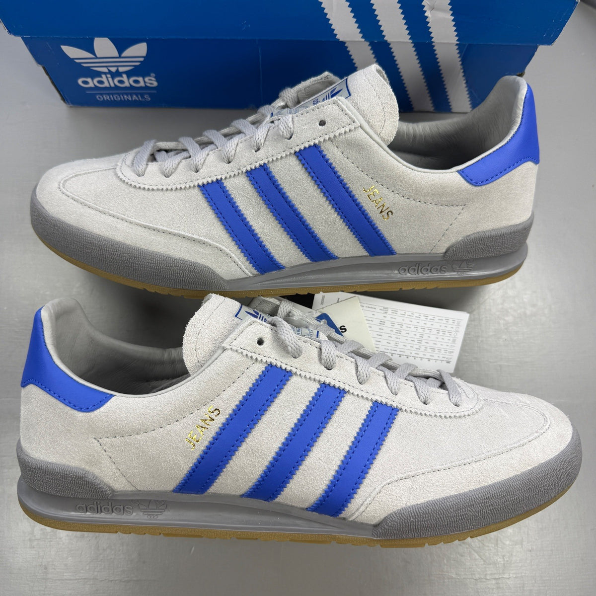 Adidas grey deck shoes with suede material and logo detail.