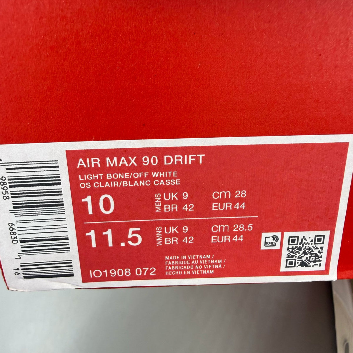 Nike Air Max 90 beige trainers with swoosh logo and mesh detailing.