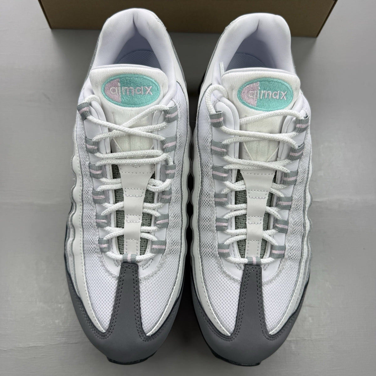 Nike Air Max 95 trainers white with turquoise and pink accents, big bubble design.