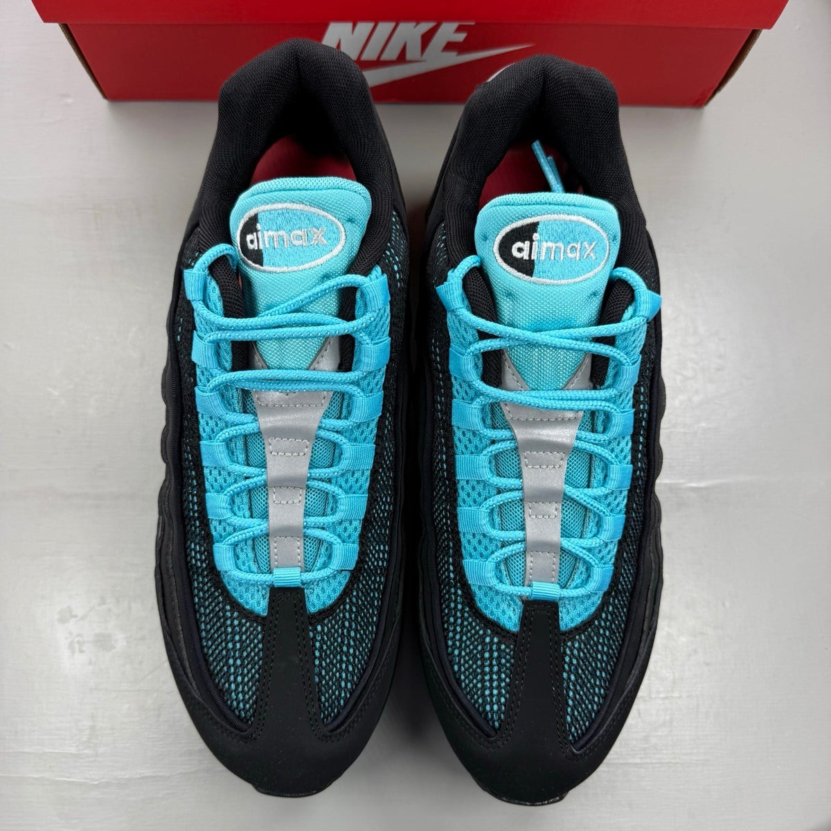 Nike Air Max 95 black sneakers with blue accents and big bubble sole design.