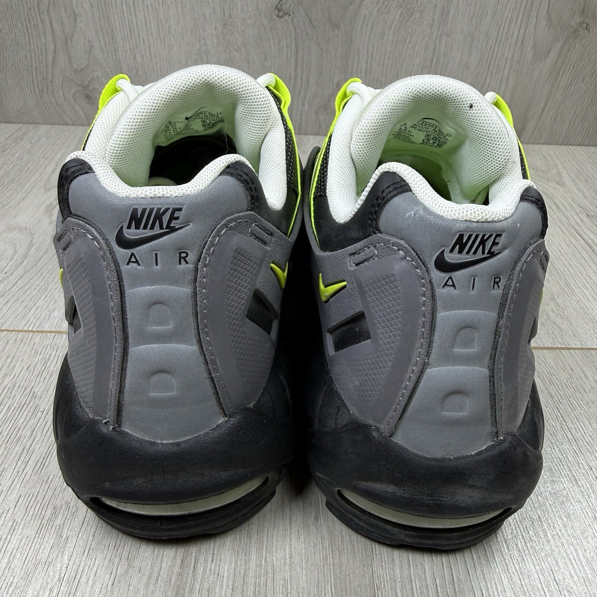 Nike Air Max 95 NDSTRKT black trainers with neon accents and textured mesh upper.