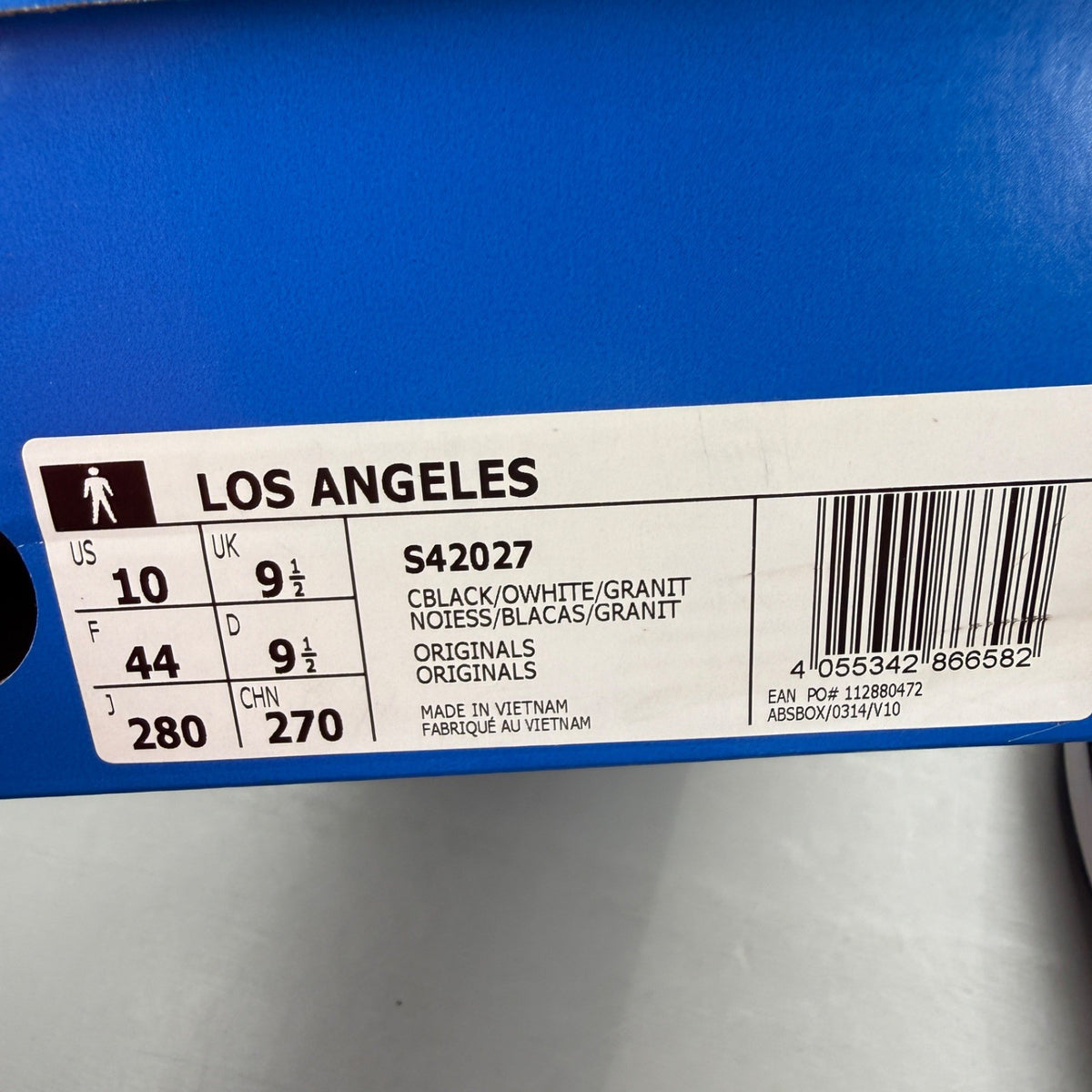 Adidas black deck shoes with white stripes and logo, brand new in box.
