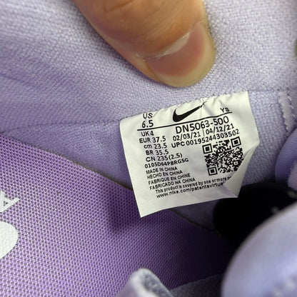 Nike Air Force 1 '07 purple trainers with classic white sole and logo detail.