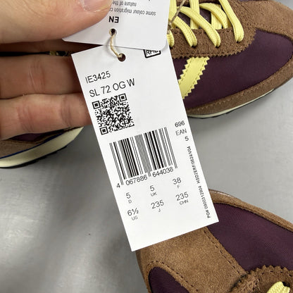 Adidas brown trainers with retro design and classic logo detail.