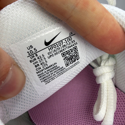 Nike athletic shoes white with pink accents and signature Air Max Plus design.
