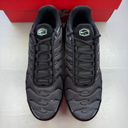 Nike Air Max Plus TN black trainers with mint green accents and signature logo.