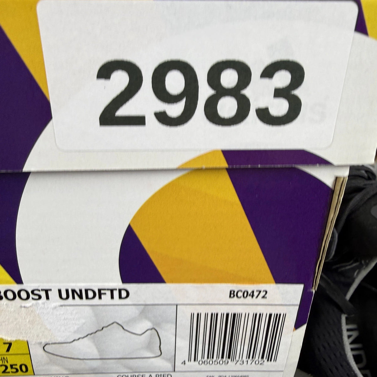 Adidas Ultra Boost black trainers with Undefeated logo and breathable mesh upper.