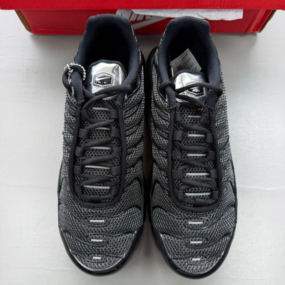 Nike black trainers suede material with silver accents and iconic Air Max Plus design.