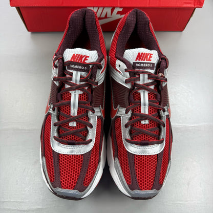 Nike Zoom Vomero 5 black trainers with red accents and white logo details.