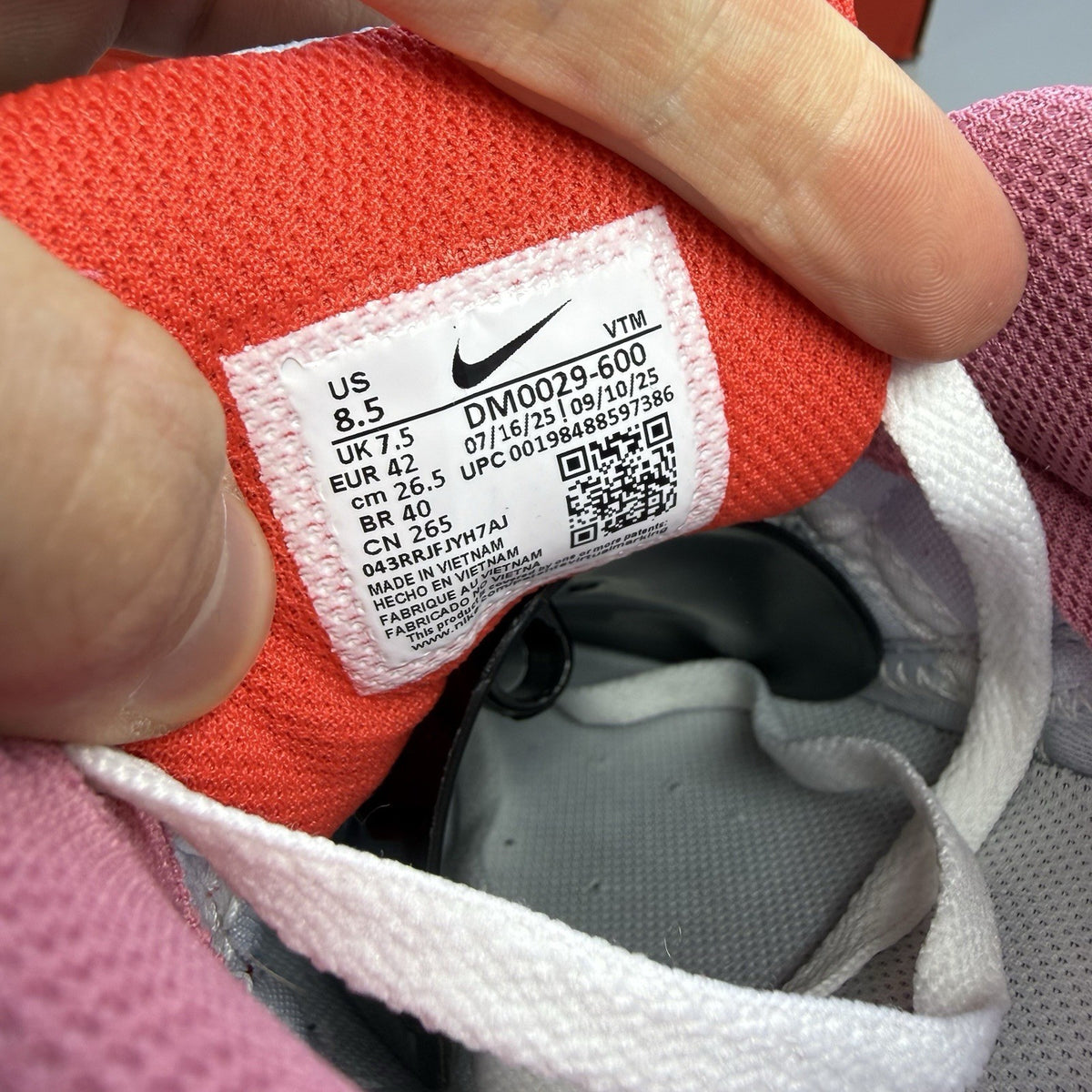 Nike Air Max 90 red trainers with white accents and signature swoosh logo.