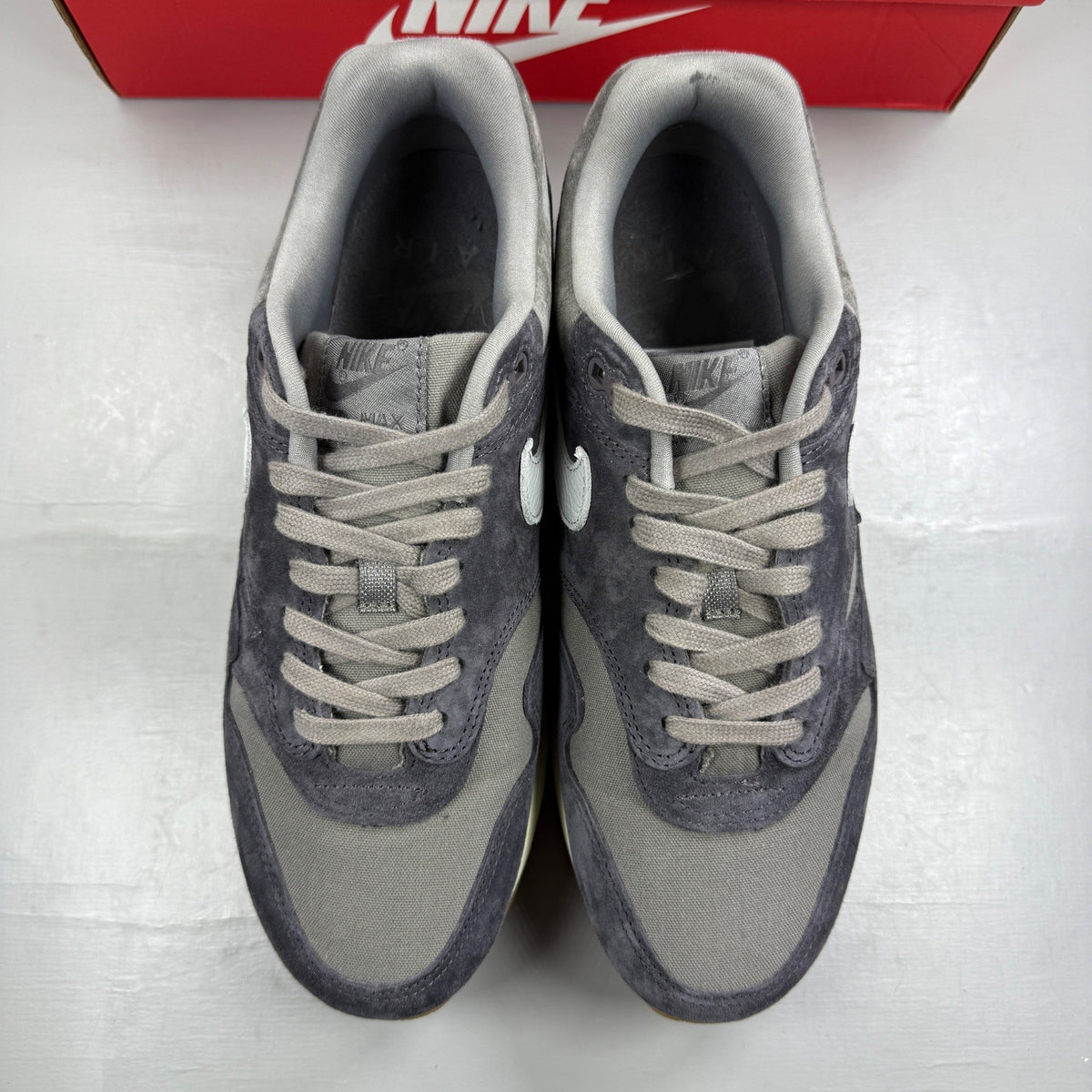Nike grey deck shoes with premium crepe sole and logo detailing.