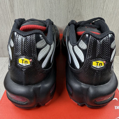 Nike TN Air Max Plus trainers black with red gradient and signature logo design.