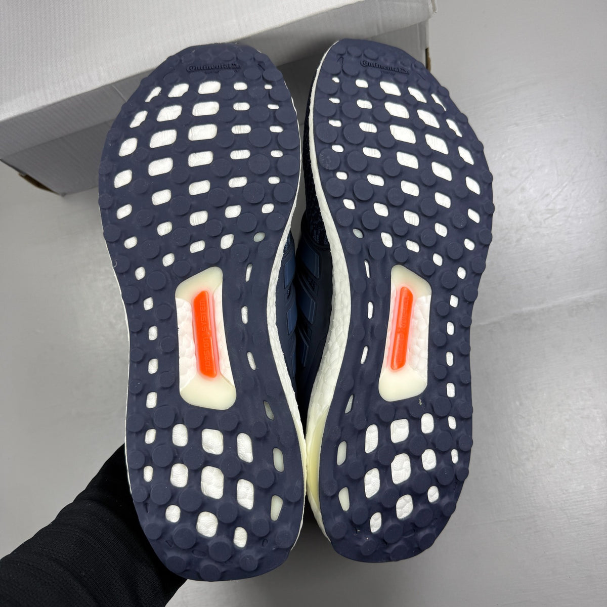Adidas running shoes blue with Boost cushioning and iconic three-stripe logo.