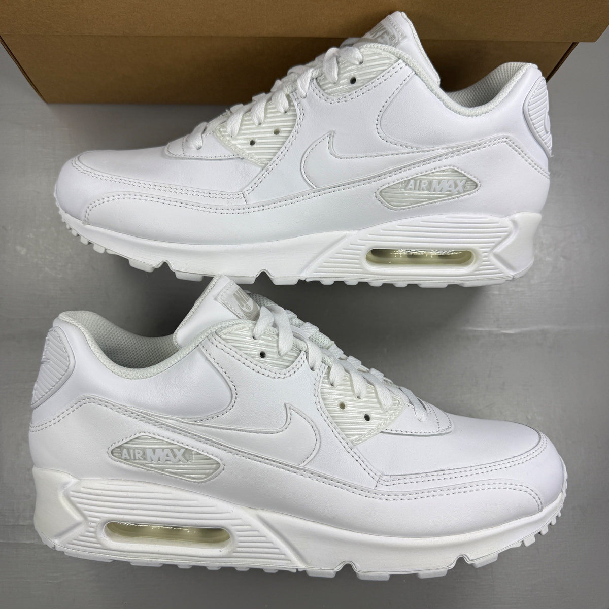 Nike white trainers leather upper with Air Max cushioning and classic logo details.