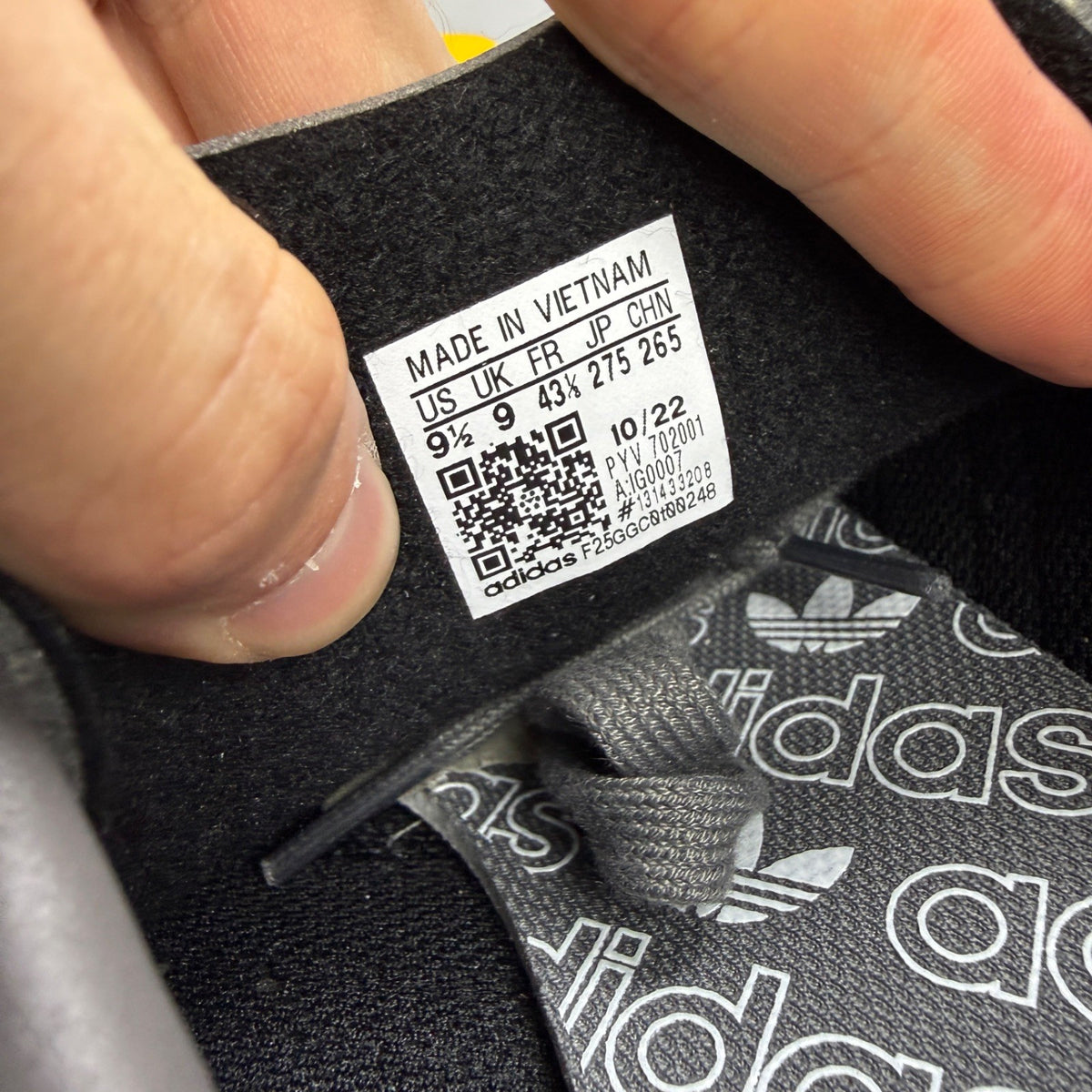 Adidas grey skate shoes with black accents and logo detail on tongue.