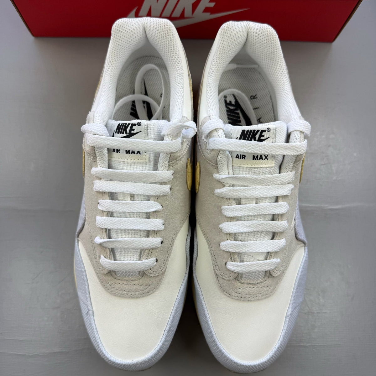Nike Air Max 1 trainers beige with crepe sole and subtle logo detailing.