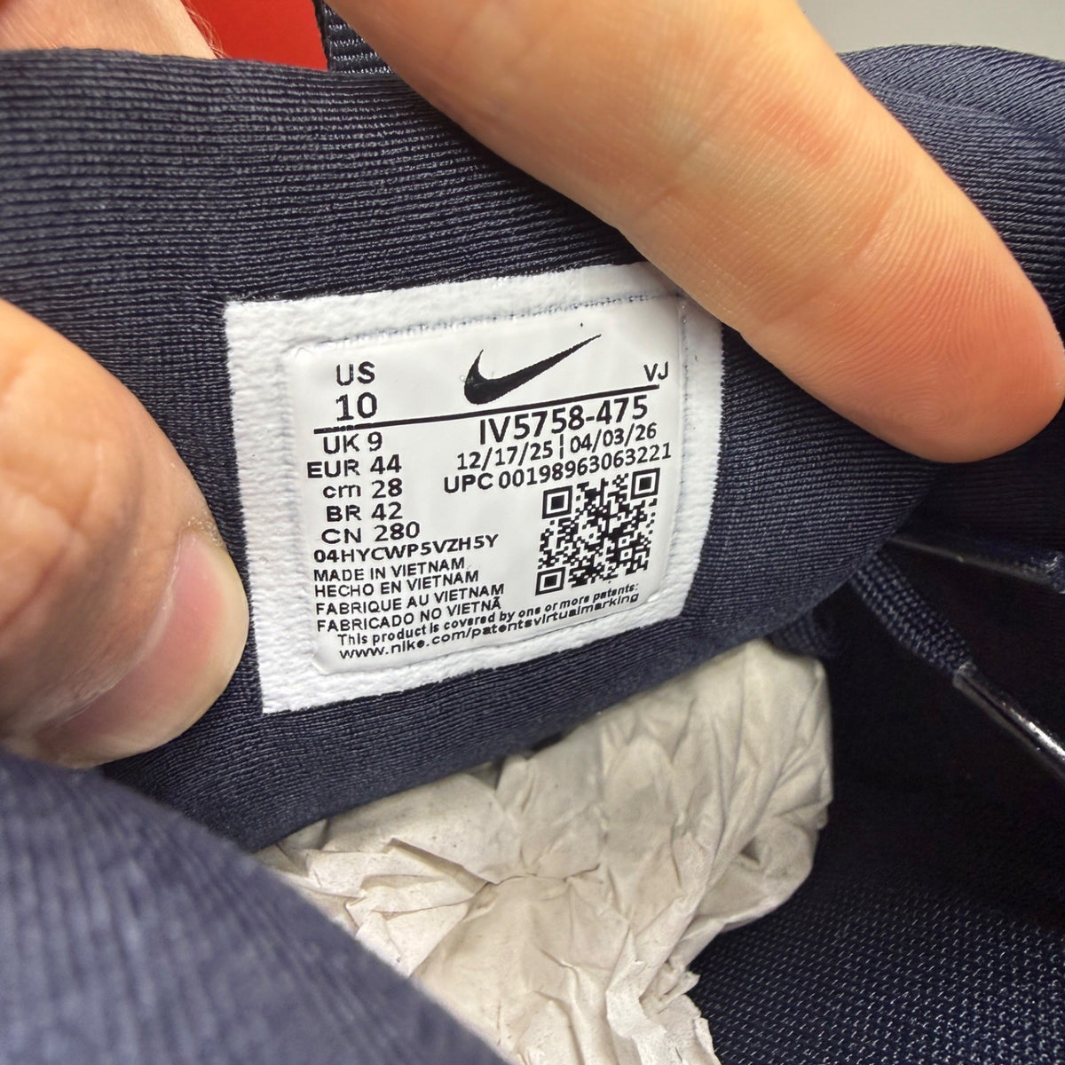 Nike Air Max 90 blue trainers with dark obsidian accents and signature swoosh logo.
