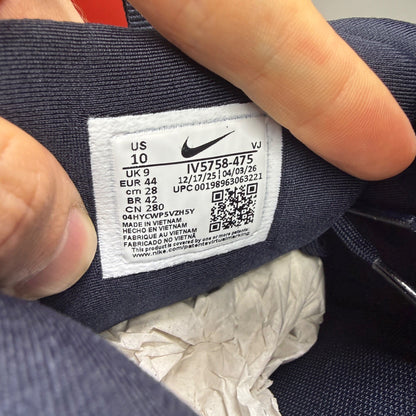 Nike Air Max 90 blue trainers with dark obsidian accents and signature swoosh logo.
